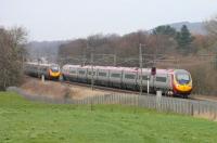 Two services running between Euston and Glasgow pass at the site of Brock water troughs just south of Garstang on 5 March. Both trains were formed by nine-car Pendolinos and timed at just under four and a half hours for the end to end journey.    <br><br>[Mark Bartlett 05/03/2015]