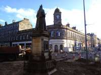 You can tell even from the back of her head that Queen Victoria is even less amused than usual that her eternal view of Leith Central station frontage is spoiled by the extensive road works currently going on at the foot of the Walk in March 2015.<br>
<br><br>[David Panton 12/03/2015]