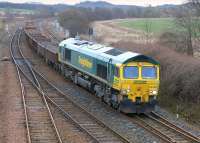 Freightliner 66550 passes Inverkeithing East Junction with spent ballast  for Millerhill on 15 March.<br><br>[Bill Roberton 15/03/2015]