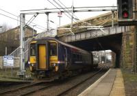 ScotRail 156453 leaves its penultimate stop at Springburn on a service from Falkirk Grahamston to Glasgow Queen Street on 17th March 2015.<br><br>[Colin McDonald 17/03/2015]