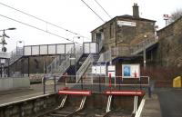 Bay platforms 3 and 4, the station building and its slightly 'Heath Robinson' connection to the footbridge at Springburn on 17th March 2015.<br><br>[Colin McDonald 17/03/2015]