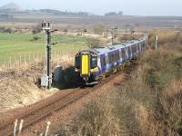 Slowing for the approach to Drem Junction on 19 March 2015, ScotRail emu 380105, forming the 1227 North Berwick - Edinburgh Waverley service, is about to leave the branch and join the east coast main line.<br><br>[John Furnevel 19/03/2015]
