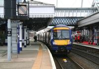 The 1013 Dunblane - Glasgow Queen Street boards at Stirling platform 3 on 1 April 2015, while the Abellio launch celebrations continue over on platform 2.<br><br>[John Furnevel 01/04/2015]