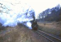 Standard tank 80046 makes steamy progress past Thorntonhall goods siding on the climb up from Busby with the 1708 St Enoch - East Kilbride in April 1966.<br><br>[John Robin /04/1966]
