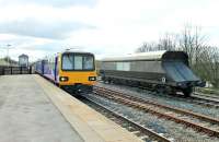 The Leeds to Heysham Port <I>Boat Train</I> slows for the Hellifield stop on Easter Saturday 2015. Three car 144022 is just passing a Freightliner coal wagon that was presumably removed from an S&C freight due to a problem. <br><br>[Mark Bartlett 04/04/2015]