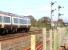 A northbound service from Glasgow Queen Street passing Larbert Junction on the approach to Larbert station in April 2006. The line south is signalled for Carmuirs West Junction and the Glasgow route.<br><br>[John Furnevel 26/04/2006]