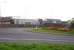 View across the A55 roundabout on the approach to Holyhead Port in October 2012. On the right is the signal box, with the Arriva Trains Wales two road TMD servicing shed on the left. [See image 40339]<br><br>[David Pesterfield 02/10/2012]