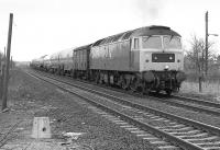 An unidentified class 47 nears Fencehouses with a train of chemical tanks on Saturday 18 March 1989, thought to be the SAI train from Leith South to Haverton Hill [see image 32436]. Trains were being diverted via the Leamside route due to electrification work on the ECML. [Ref query 3307]<br><br>[Bill Roberton 18/03/1989]