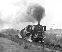 Although the border town of Gmuend in Lower Austria retained a large allocation of 2-8-2T locos until 1976, there was little in the way of standard gauge steam working in and out of the town itself (operations were centred on the sub-shed at Schwarzenau some 15 miles to the east), so that apart from a couple of workings on the narrow-gauge, the highlight of a morning spent there was the appearance of a transfer freight from Ceske Velenice on the Czech side of the border. This was normally worked by CSD No. 556 0506, a Skoda built 2-10-0 to a very advanced design, of which 510 examples were constructed between 1951 and 1958. It is seen here between the border and Gmuend station on 11th September 1975.<br><br>[Bill Jamieson 11/09/1975]