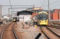 View from a city bound tram approaching Cornbrook, which opened to passengers in 1999 but was only an interchange between Altrincham and Eccles trams until 2006 when a street access point opened. The approaching tram is passing over the points for the Eccles line while to the right are the Network Rail tracks of the Irlam and Warrington line.  <br><br>[Mark Bartlett 20/04/2015]