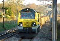 Travelling north on the Down Fast line passed Euxton Balshaw Lane station, Freightliner 70005 hauls a Network Rail ballast train on 18 April 2015.<br><br>[John McIntyre 18/04/2015]