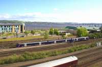 An Inverurie - Edinburgh service climbs west out of Dundee towards the Tay Bridge on 16th May 2015. The coach in the siding is a staff car off the <I>Royal Scotsman</I> with an axle problem awaiting attention.<br><br>[Colin McDonald 16/05/2015]