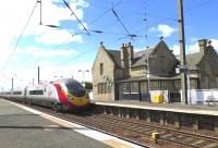 Virgin Pendolino 390115 races through Kirknewton on 26 May 2015 on the 08:43 service from London Euston to Edinburgh Waverley.<br><br>[Malcolm Chattwood 26/05/2015]
