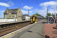The Caledonian Railway station building at Kirknewton provides an interesting contrast in style with the contemporary bike shelter on the opposite platform as 158724 passes through with an Edinburgh Waverley to Glasgow Central (via Shotts) express.<br><br>[Malcolm Chattwood 26/05/2015]