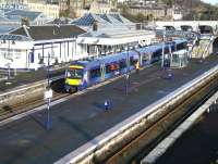 A bright and sunny morning at Stirling station platform 9 on 1 April 2015 sees the 0836 Alloa - Glasgow Queen Street marking time during its scheduled 8 minute stopover here, following a 9 minute journey from Alloa.<br><br>[John Furnevel 01/04/2015]
