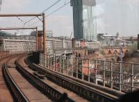 Driver's view from a Metrolink service running on to the (1877) Cornbrook Viaduct. To the right are the lower main line tracks on the original Castlefield Viaduct and Castlefield Junction where the trams are carried over the line to Ordsall. To the left, hidden by the lattice, is the now disused Castlefield (1894) Viaduct. Both the high level bridges led to Manchester Central, which can just be seen to the right of the Beetham Tower.  <br><br>[Mark Bartlett 20/04/2015]