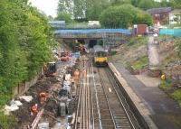 A Manchester Victoria to Clitheroe service exits the smaller Farnworth Tunnel and passes through the temporarily closed station on 2 June 2015. On my last visit the Up platform was being excavated to allow for realignment. The blockwork wall for the new alignment is now starting to appear on the left but the major change will be the removal of the road bridge in the background.<br><br>[John McIntyre 02/06/2015]