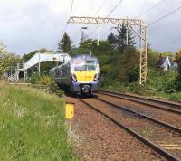 ScotRail 334003 slowing for the stop at Cardross on 31 May 2015 with a service for Helensburgh Central. Photographed looking west from Bainfield foot crossing.<br><br>[John McIntyre 31/05/2015]
