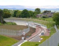 The Borders Railway crossing Hardengreen Viaduct over the A7 on 3 June 2015. Photographed looking south towards Dalhousie Mains from the pedestrian footbridge near the new Eskbank station. <br><br>[John Furnevel 03/06/2015]