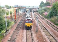 Longannet empties heading back to Hunterston in August 2006 behind EWS 66145 passing Rutherglen Central Junction. The train is about to run under the pedestrian walkway linking Rutherglen station with Victoria Street.<br><br>[John Furnevel 15/08/2006]
