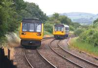 Blackpool South to Colne meets Colne to Blackpool South once again, this time on 17 June 2015 near Hoghton as 142038 on the left heads east passing 142053.<br><br>[John McIntyre 17/06/2015]