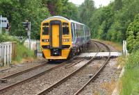 Northern 158752 crosses Hoghton level crossing heading west on 17 June 2015 with a York - Blackpool service.<br><br>[John McIntyre 17/06/2015]