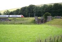 A northbound Pendolino approaching Crawford on the WCML in August 2009. The train is passing the site of the yard that once acted as an interchange point with the 3 ft gauge Camps Railway (built to facilitate the construction of Camps Reservoir). View is south towards the bridge which took the NG line across the River Clyde.<br><br>[John Furnevel 05/08/2009]
