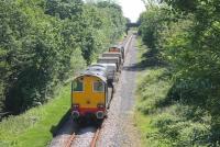 A pair of DRS Class 20s trundling along the Heysham branch on 23rd June 2015, taking three flasks to the nuclear power station. 20309 is bringing up the rear of a train headed by 20305 in this view towards the port from the bridge at Heysham Moss (Map Ref SD 423613). This was the last year that DRS used the English Electric Type 1s on this duty.<br><br>[Mark Bartlett 23/06/2015]
