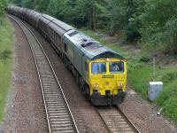Freightliner 66605 coasts downhill towards Dalgety Bay with the Aberdeen - Oxwellmains cement empties on 30 June.<br><br>[Bill Roberton 30/06/2015]