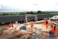 Contractors working at the construction site of the new Bargeddie bridge on 29th June 2015, seen from a passing train.  The bridge is due to be moved into position during a line closure from 11th - 26th July.<br><br>[Colin McDonald 29/06/2015]