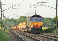 6am on 12th June 2015 and the early morning sun illuminates DRS 66433 and a long infrastructure train making its way north from Crewe to Carlisle, seen here approaching Woodacre. <br><br>[Mark Bartlett 12/06/2015]