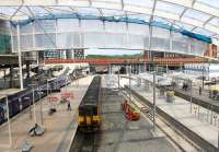 Just a little more tidying around the new Metrolink section of Manchester Victoria and the station will be ready to receive trams from the link to Exchange Square that may open later in 2015, ahead of the full <I>second city crossing</I>. 155341 leaves from the Network Rail side of Victoria on 25th June 2015, heading for Leeds via Todmorden and Dewsbury.  <br><br>[Mark Bartlett 25/06/2015]