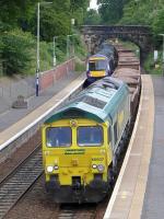 Freightliner 66607 coasts through Dalgety Bay with a Winchburgh Junction - Millerhill ballast on 12 July, having just passed 170476 on a stopping service.<br><br>[Bill Roberton 12/07/2015]