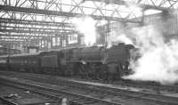 The 10.10am Edinburgh Princes Street - Birmingham New Street stands at Carlisle platform 4 on 11 April 1964. The locomotive is Britannia Pacific 70040 <I>Clive of India</I>.<br><br>[K A Gray 11/04/1964]