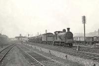 Ex-Caledonian 0-6-0 57592 passes Dalmuir Riverside on 11 April 1958 with an up freight.  <br><br>[G H Robin collection by courtesy of the Mitchell Library, Glasgow 11/04/1958]