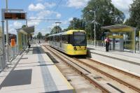 The first stop on the Manchester Airport tram line is Barlow Moor Road. Metrolink 3095, heading towards the city, leaves the Hardy Lane street running section and pulls in to the new station on 8th June 2015. <br><br>[Mark Bartlett 08/06/2015]