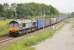 DRS 66303, with a Daventry to Coatbridge container service, runs north between the bridges at Elmsfield on 16th June 2015. The land in the foreground has been made into an engineers' access point with a ramp leading down from the bridge embankment.  <br><br>[Mark Bartlett 16/06/2015]