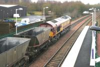 Longannet - Hunterston empties westbound through Camelon station, Falkirk, on 10 December 2004 behind EWS 66229.<br><br>[John Furnevel 10/12/2004]