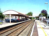 Looking north through Yatton station from the downside platform in May 2015, showing the barrel roofed canopy that previously served both the main line up side platform and the Clevedon branch bay to the left. Note also the now roofless footbridge [see image 51822].<br><br>[David Pesterfield 09/05/2015]