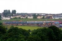 This improbable consist is actually the result of a telephoto shot of the 0624 Motherwell - Milngavie service crossing a Virgin Voyager Polmadie - Edinburgh empty stock movement on the new Bargeddie bridge on 27th July 2015, the first day of operations over the new bridge.<br><br>[Colin McDonald 27/07/2015]