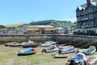 Dartmouth enjoyed all the facilities of a Great Western Railway station, except trains. Tickets could be purchased through to Paddington but the railway ferry first had to be taken across the Dart to Kingswear station. After closure in 1972 the building became the <I>Station Restaurant</I>, seen here looking across the harbour with Kingswear behind across the river. <br><br>[Mark Bartlett 31/07/2015]