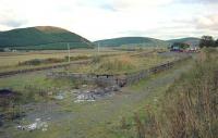 The former loading bank at Elvanfoot in 1994, with the WCML beyond the fence on the left. The station was located in the distance and the Leadhills and Wanlockhead branch joined the mainline on the left side of the loading bank.<br><br>[Ewan Crawford //1994]