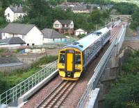 After passing the site of Kilnknowe Junction 158725 crosses the Gala Water on the northern approach to Galashiels on 11 August 2015. The train is the 0952 2Z18 Newcraighall - Tweedbank.<br><br>[John Furnevel 11/08/2015]