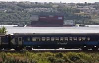 Lower Block 04 of the new carrier <I>Prince of Wales</I> heads down the River Clyde en route to Rosyth and is passed by a combined Oban and Mallaig service to Glasgow.<br><br>[Ewan Crawford 16/08/2015]