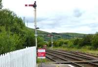 Down starters at Girvan on 12 August 2015. The tall signal refers to platform 2, the other to Platform 1. The main station building is located on platform 1, whereas platform 2 has nothing, not even a plastic shelter. Platform 1 appears to be used at all times other than when a crossing movement is required.<br><br>[Colin Miller 12/08/2015]