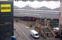 The Calton Road entrance to Waverley, photographed looking south from Waterloo Place on 27 August 2015. The train awaiting its departure time at platform 2 is the 1000 Virgin East Coast service to London Kings Cross.<br><br>[John Furnevel 27/08/2015]