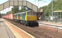 The 4M74 Coatbridge FLT to Crewe Basford Hall containers passing through Holytown station on 14 July 2015 behind Freightliner locomotives 86607+86613. <br><br>[Ken Browne 14/07/2015]