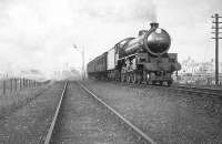 A train leaving Peterhead for Aberdeen on 19 May 1949. B1 4-6-0 no 61345 had been delivered new from Gorton works to Ferryhill six weeks earlier, before being moved across the city to Kittybrewster three days before this photograph was taken. [Ref query 17693]<br><br>[G H Robin collection by courtesy of the Mitchell Library, Glasgow 19/05/1949]