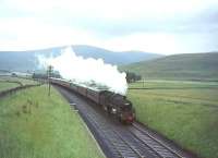 Standard class 5 4-6-0 no 73064 approaching the A74 bridge south of Crawford on 10 July 1965 with a CTAC special heading for Leicester.<br><br>[John Robin 10/07/1965]
