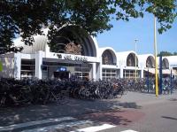 <I>On yer bike!</I> Station frontage and commuter parking at Gouda in July 2015. The present station building dates from 1984, succeeding a short term replacement for one destroyed by the RAF for strategic reasons in November 1944. Gouda is on the Rotterdam/Utrecht line, with other lines running from the town to den Haag and Alphen an den Rijn and enjoys a wide variety of Inter-City and  local Sprinter services around the country. Even on a Sunday evening there are some 20 arrivals/departures an hour.<br><br>[Andrew Wilson 16/07/2015]